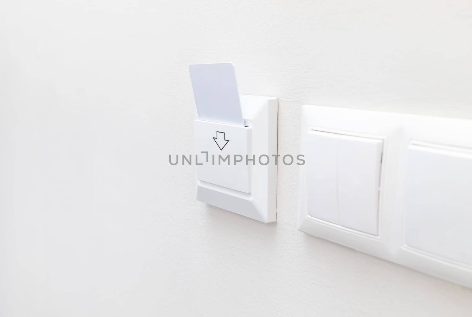 Hotel White Key Card Reader With Card For Powering Electricity. Hotel Key Card On Main Switch To Enable The Electric Circuit In Hotel Rooms. Horizontal Plane. Copy Space. Energy Saving.