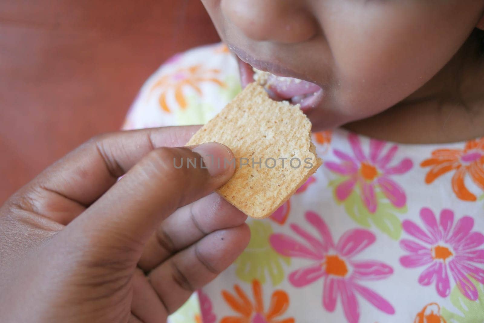 child mouth eating potato chips .