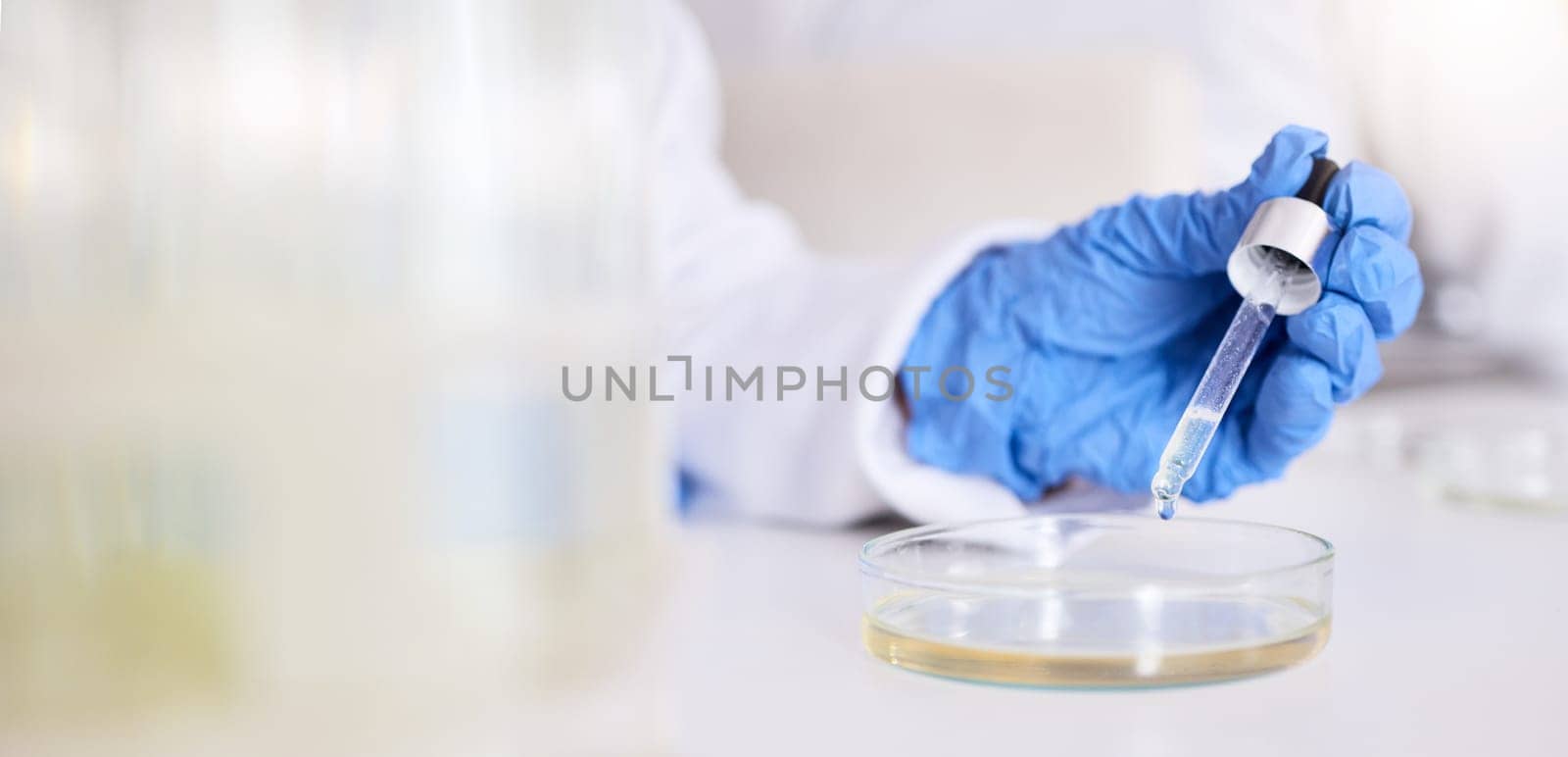 Hand, petri dish and liquid, chemical and pipette in laboratory with scientist person and experiment. Liquid solution, glass and test for medical research, science study and chemistry with closeup by YuriArcurs