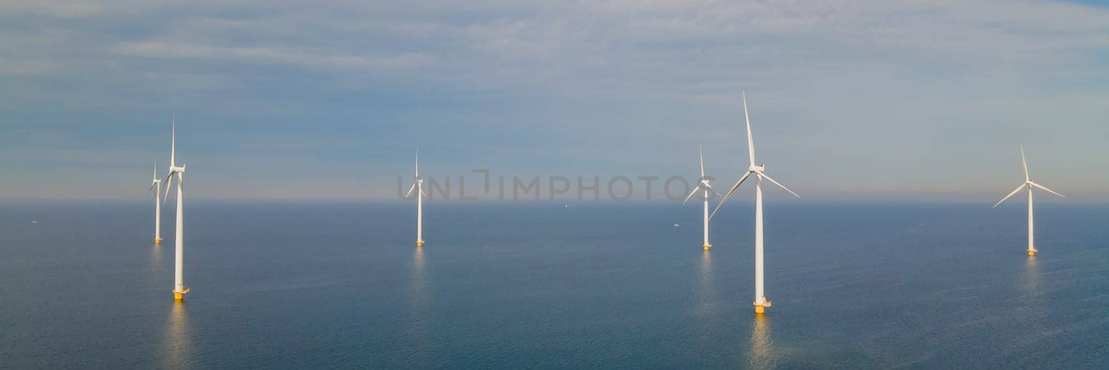 A photo of an offshore wind farm with turbines in the ocean in the Netherlands