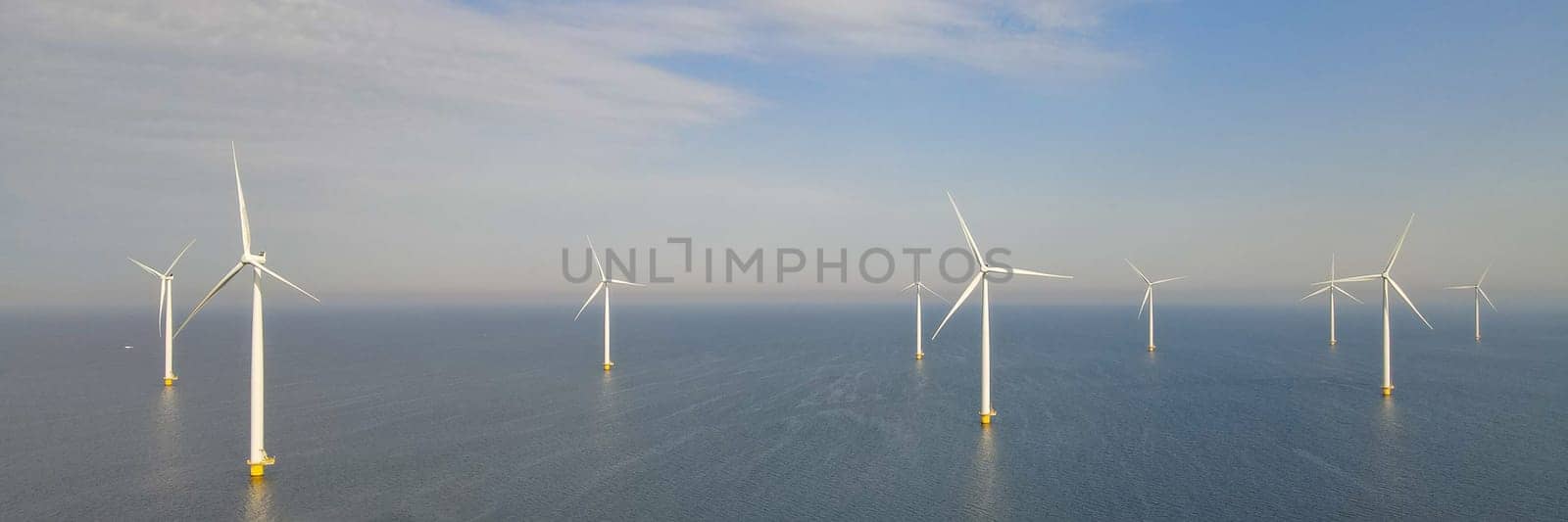 offshore windmill park with clouds and a blue sky by fokkebok