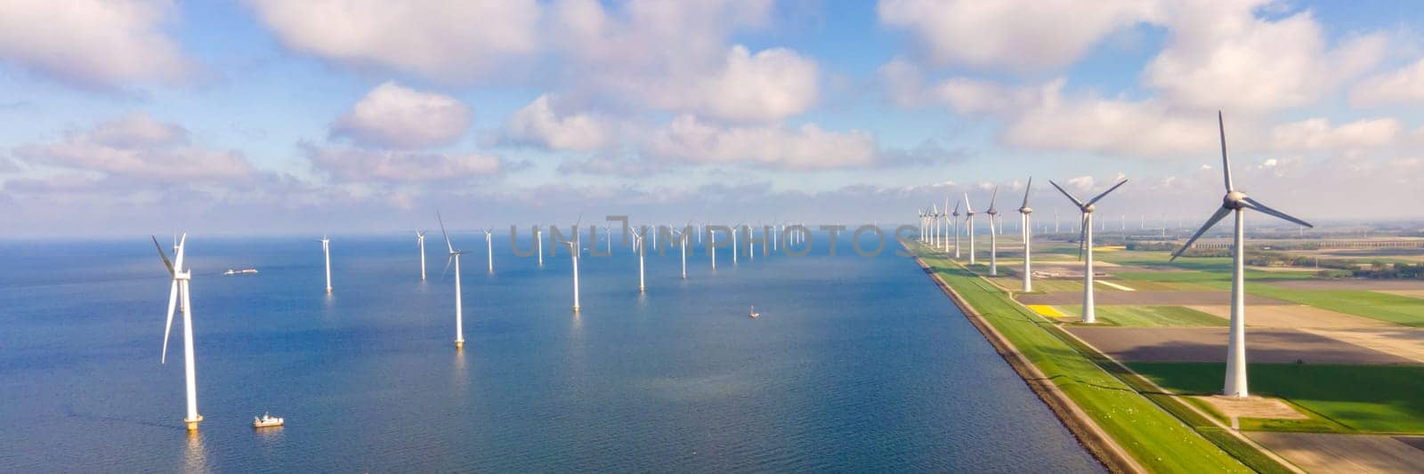 offshore windmill park with clouds and a blue sky by fokkebok