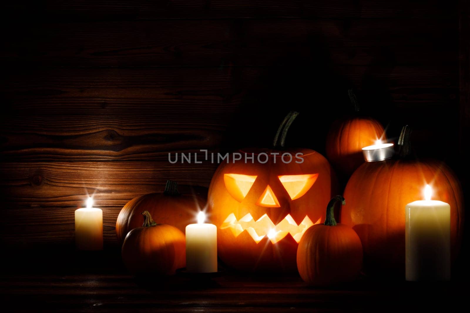 Halloween pumpkins with cut faces and candles dark holiday card