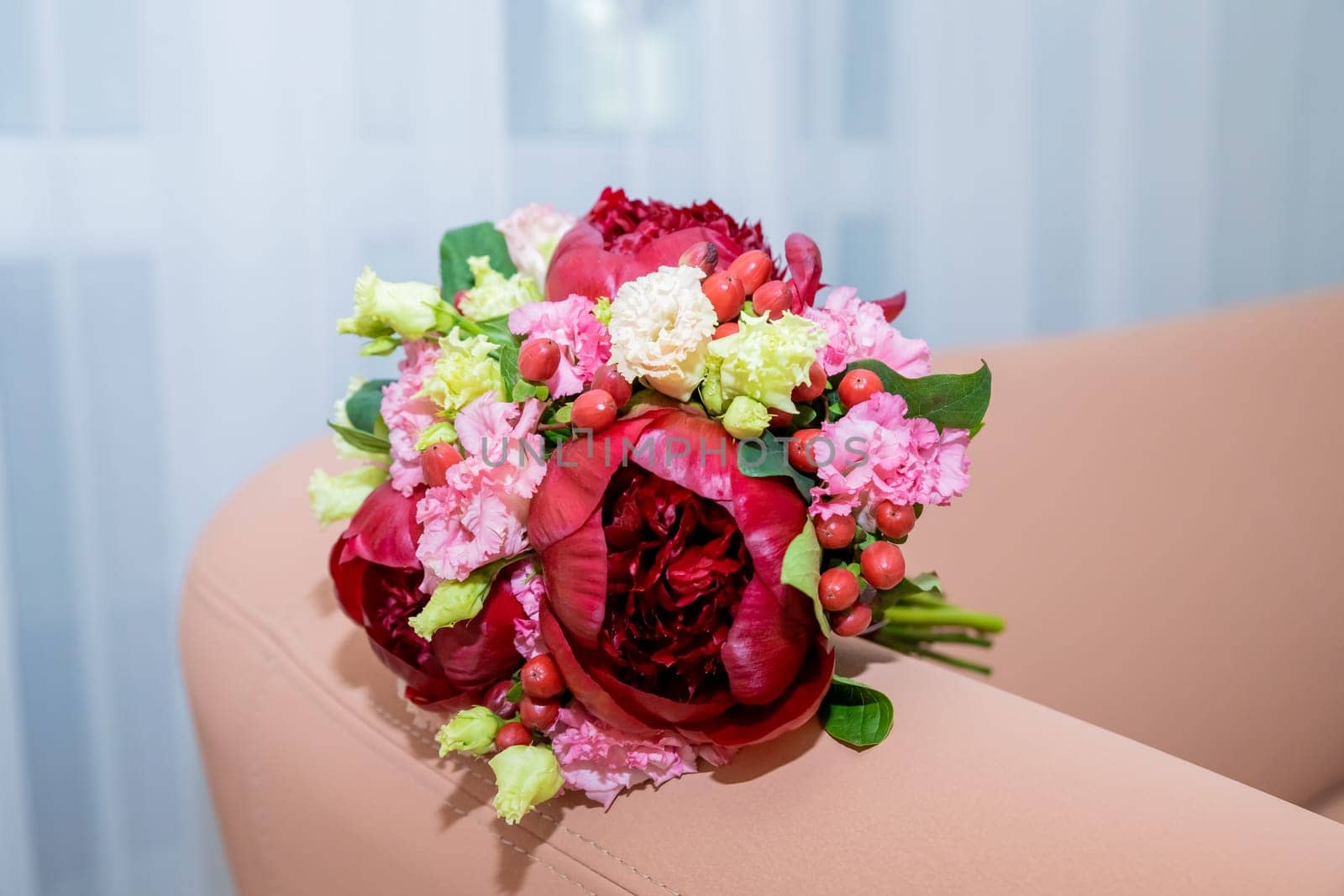Wedding flowers, red color, bridal bouquet closeup. Decoration made of roses, hypericum