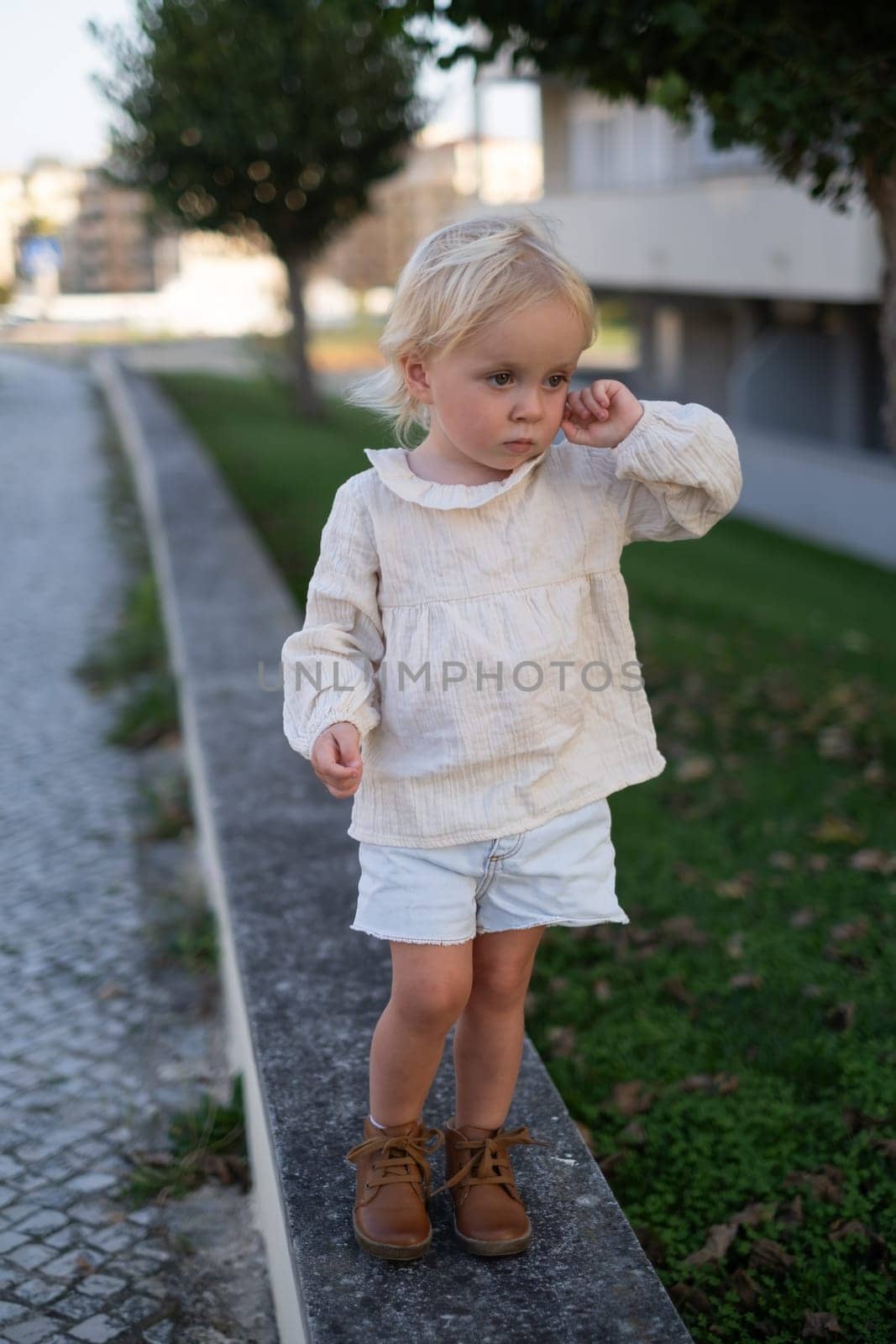 Beautiful little caucasian girl walking outdoor feeling alone and sad