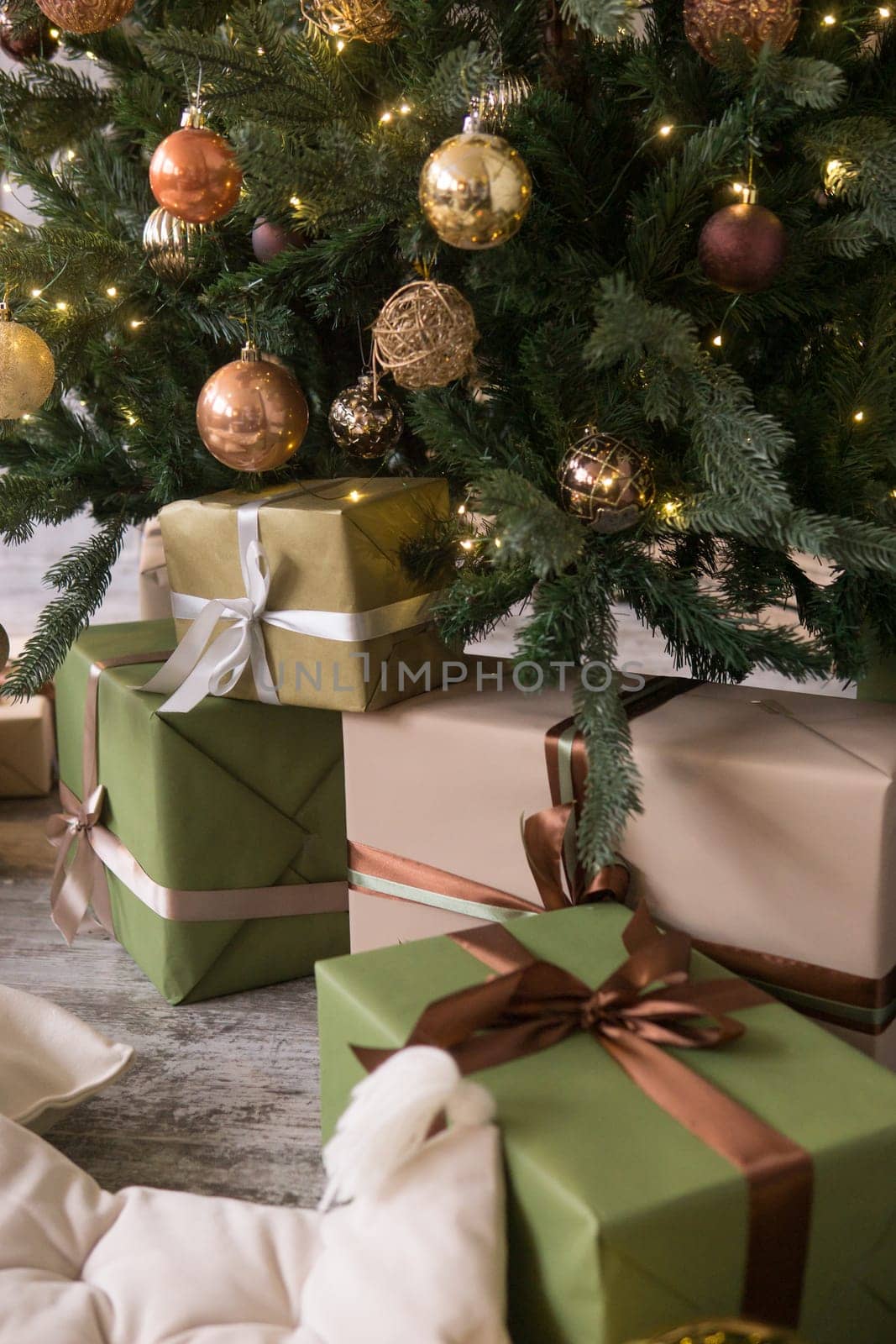Bronze balls on the Christmas tree close-up. Christmas tree design decorations. The concept of celebrating New Year and Christmas