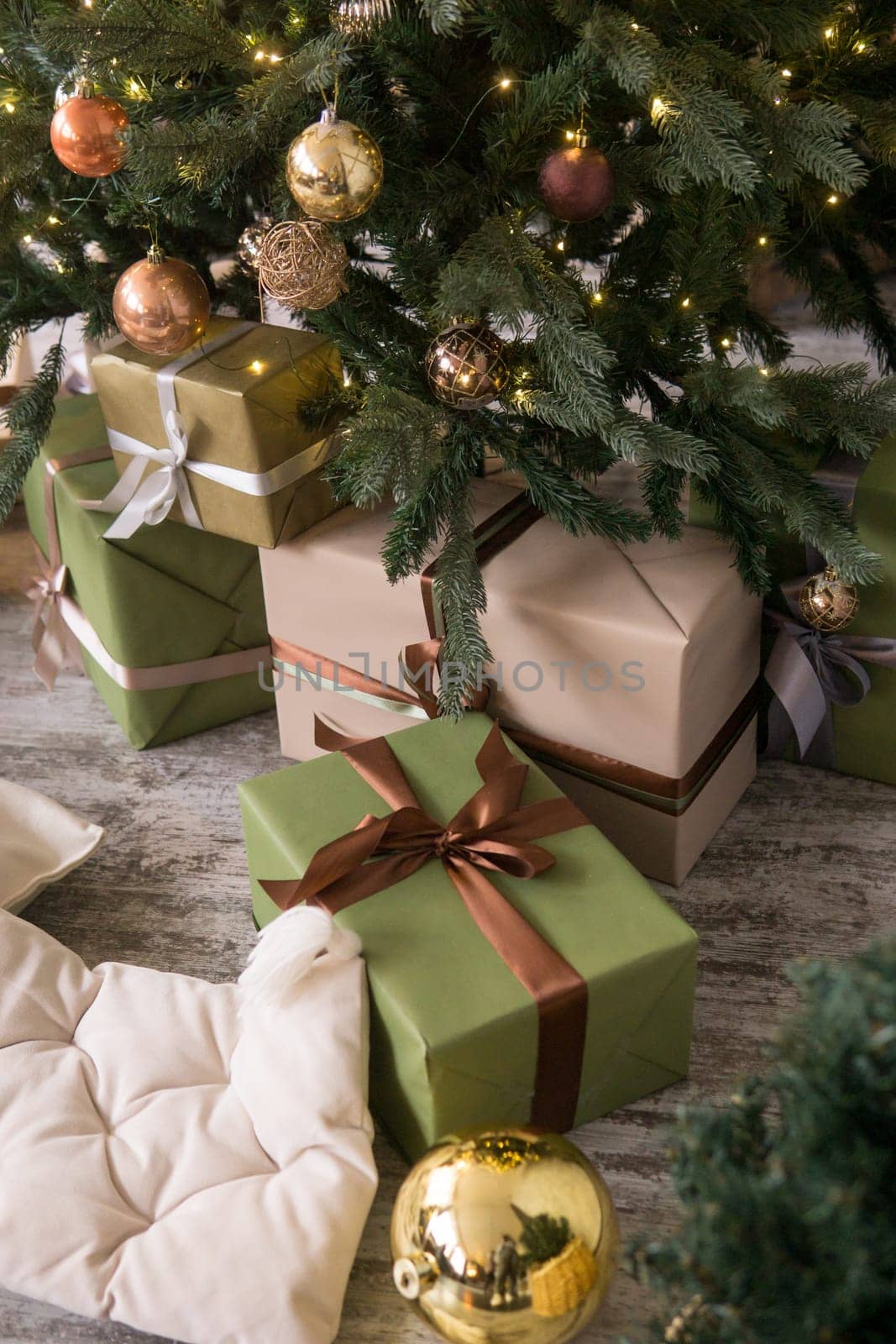 Bronze balls on the Christmas tree close-up. Christmas tree design decorations. The concept of celebrating New Year and Christmas