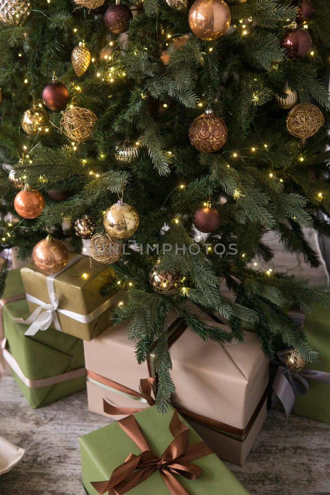 Bronze balls on the Christmas tree close-up. Christmas tree design decorations. The concept of celebrating New Year and Christmas