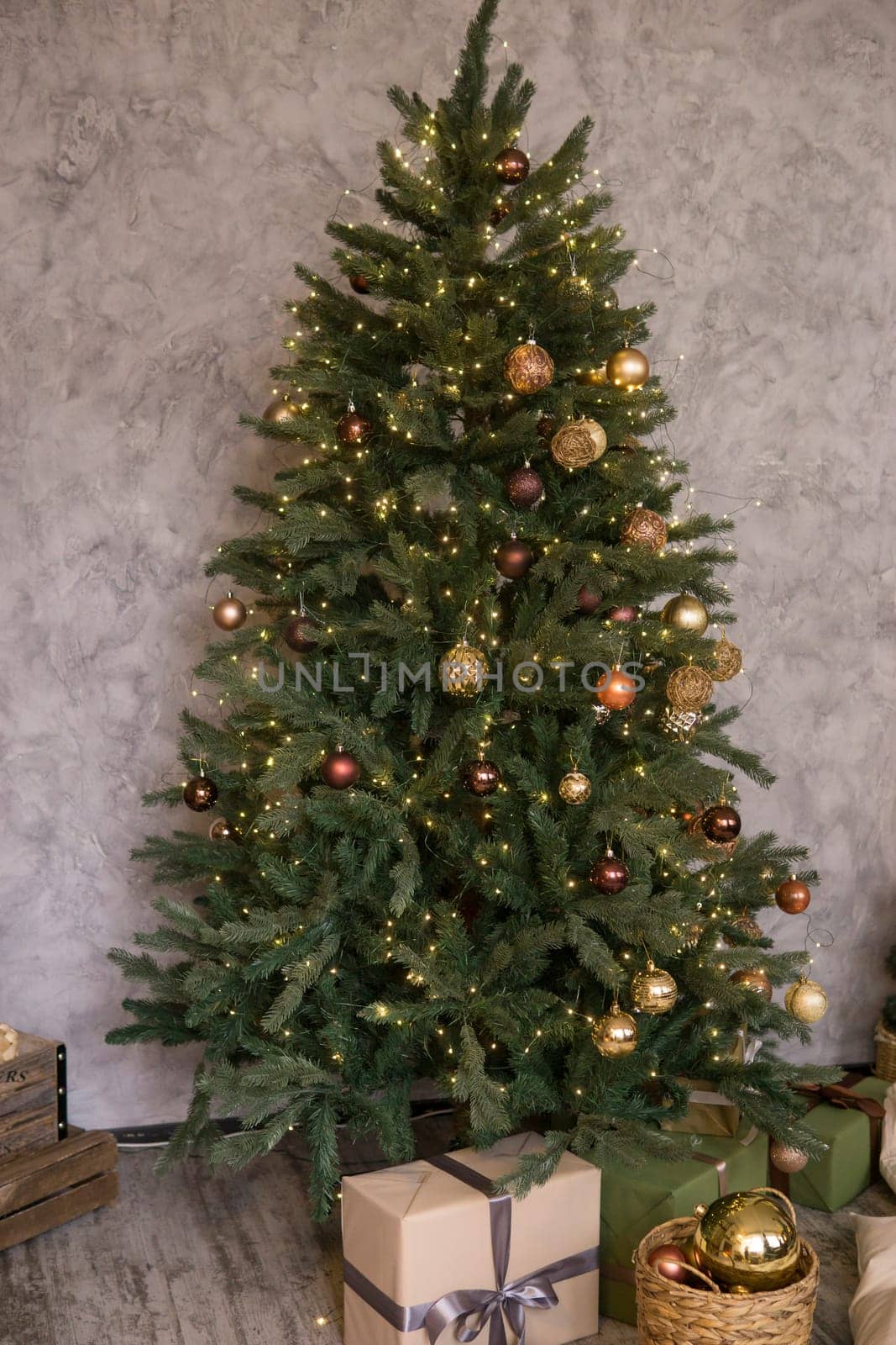 Home New Year's interior. Christmas tree with gifts, decorated with garlands. Cozy atmosphere of a home holiday, loft design of the room, Scandinavian style