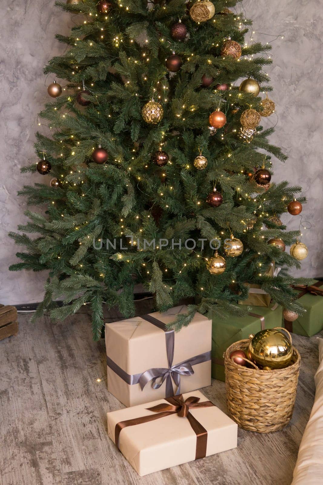 Home New Year's interior. Christmas tree with gifts, decorated with garlands. Cozy atmosphere of a home holiday, loft design of the room, Scandinavian style