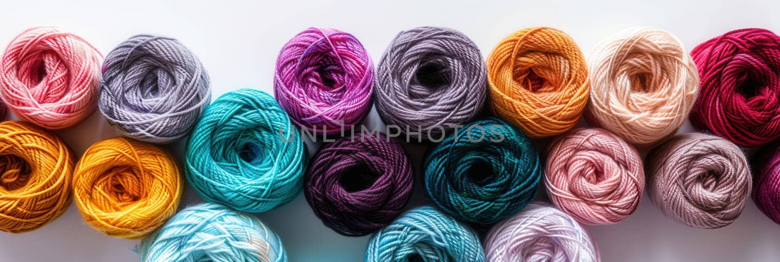 A grid of vibrant yarn rolls displayed on a white background, perfect for various crafting activities and creative projects.