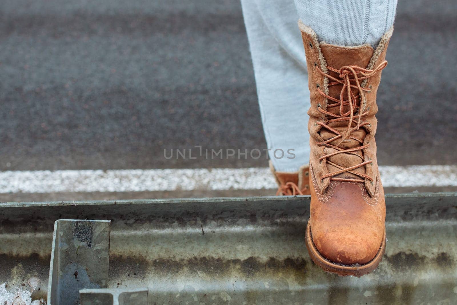 Leather boot on the side of the road stop before a long journey. A long walk in search of adventure.