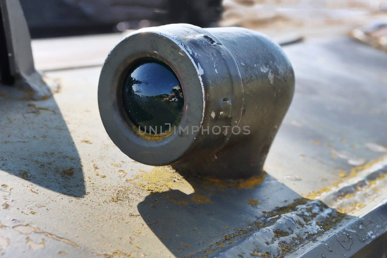Close-up of a special green illuminator on military equipment.