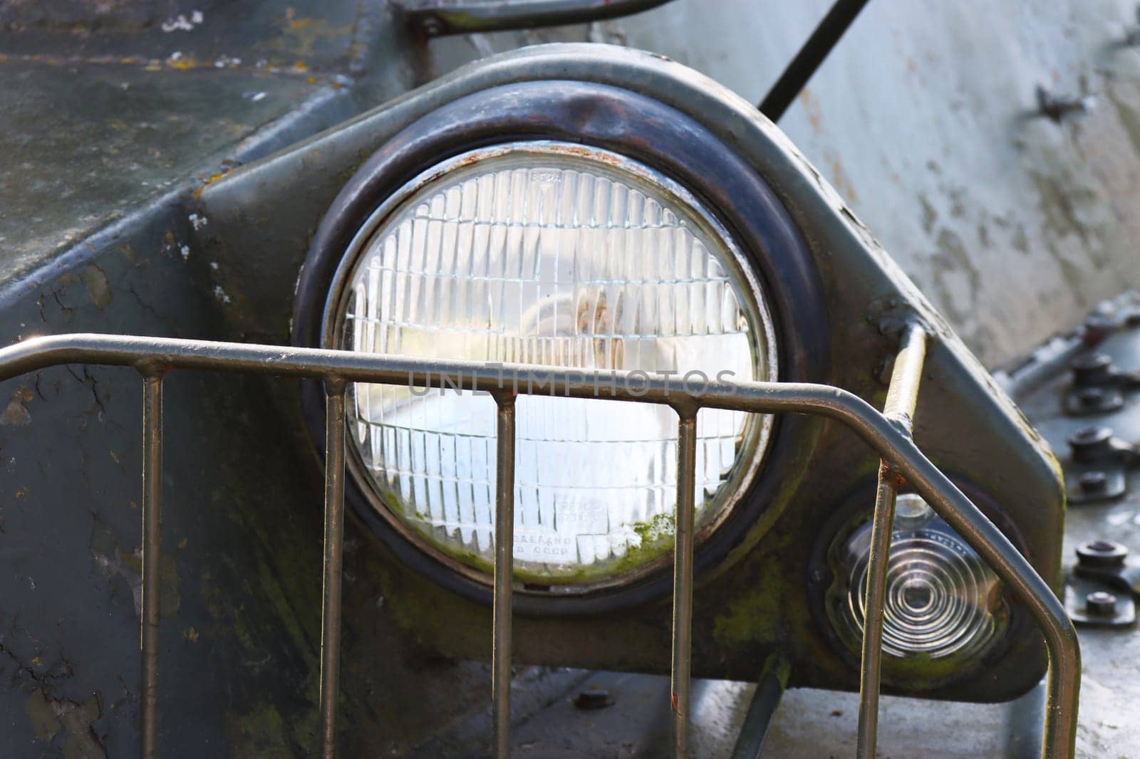 A high beam headlight protected by a special grille on old armored vehicles.
