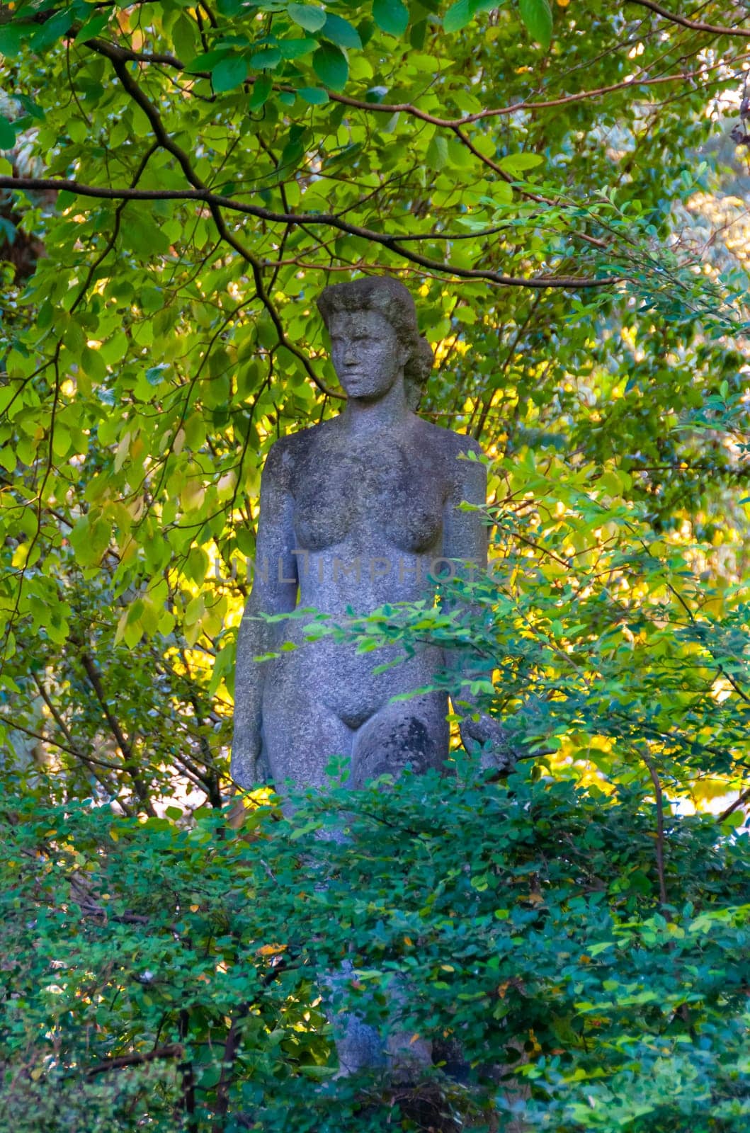 NANTES, FRANCE - SEPTEMBER 12, 2017: Sculpture of a naked woman in a park of plants in Nantes, France
