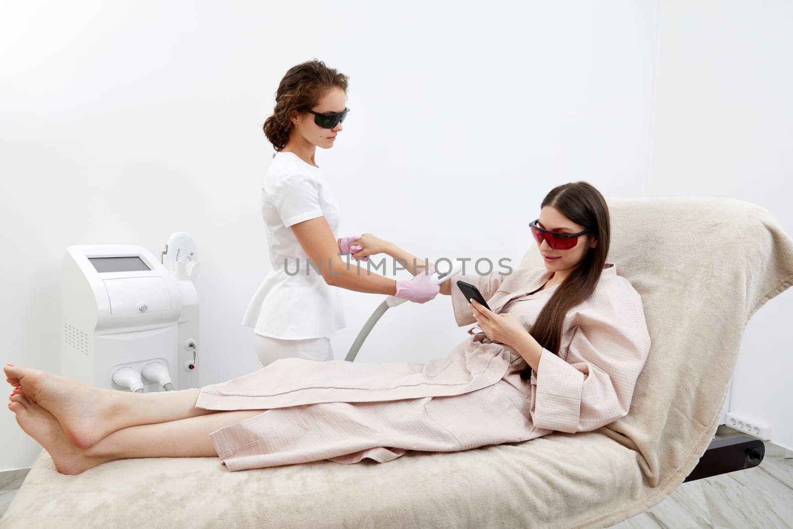 In a serene salon, woman enjoys arm hair removal using laser technology by Mariakray