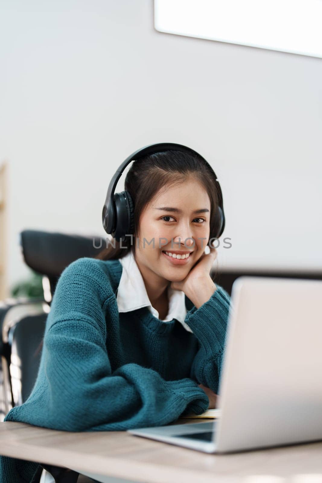 Studying online, beautiful Asian female student or student studying online at home by Manastrong