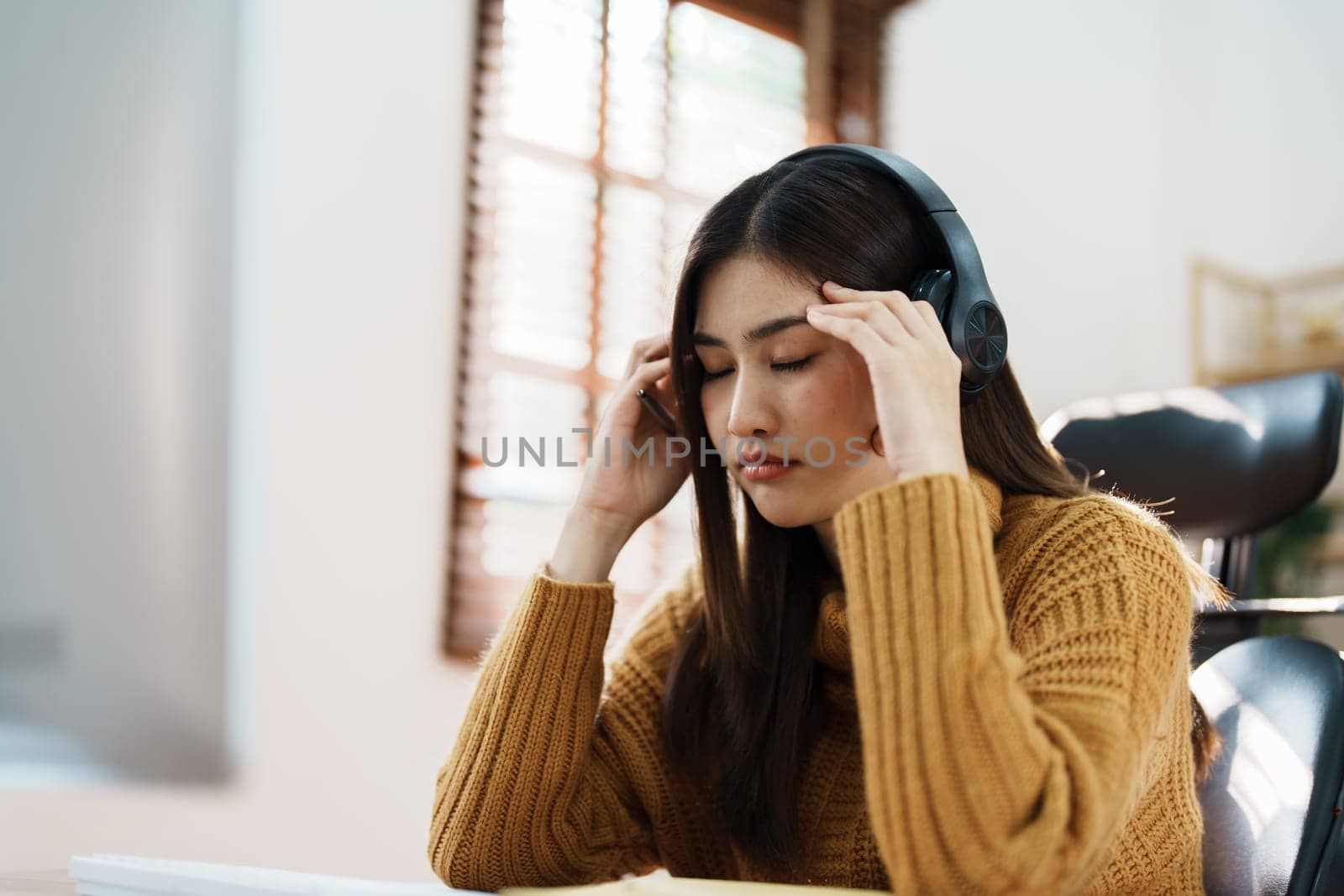 Studying online, beautiful Asian female student show symptoms burnout syndrome student studying online at home.