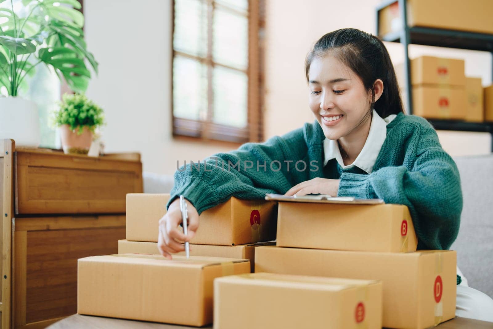 Online delivery, female small business owners are ecstatic when they see unexpected sales and customer orders in their business planning and marketing by Manastrong