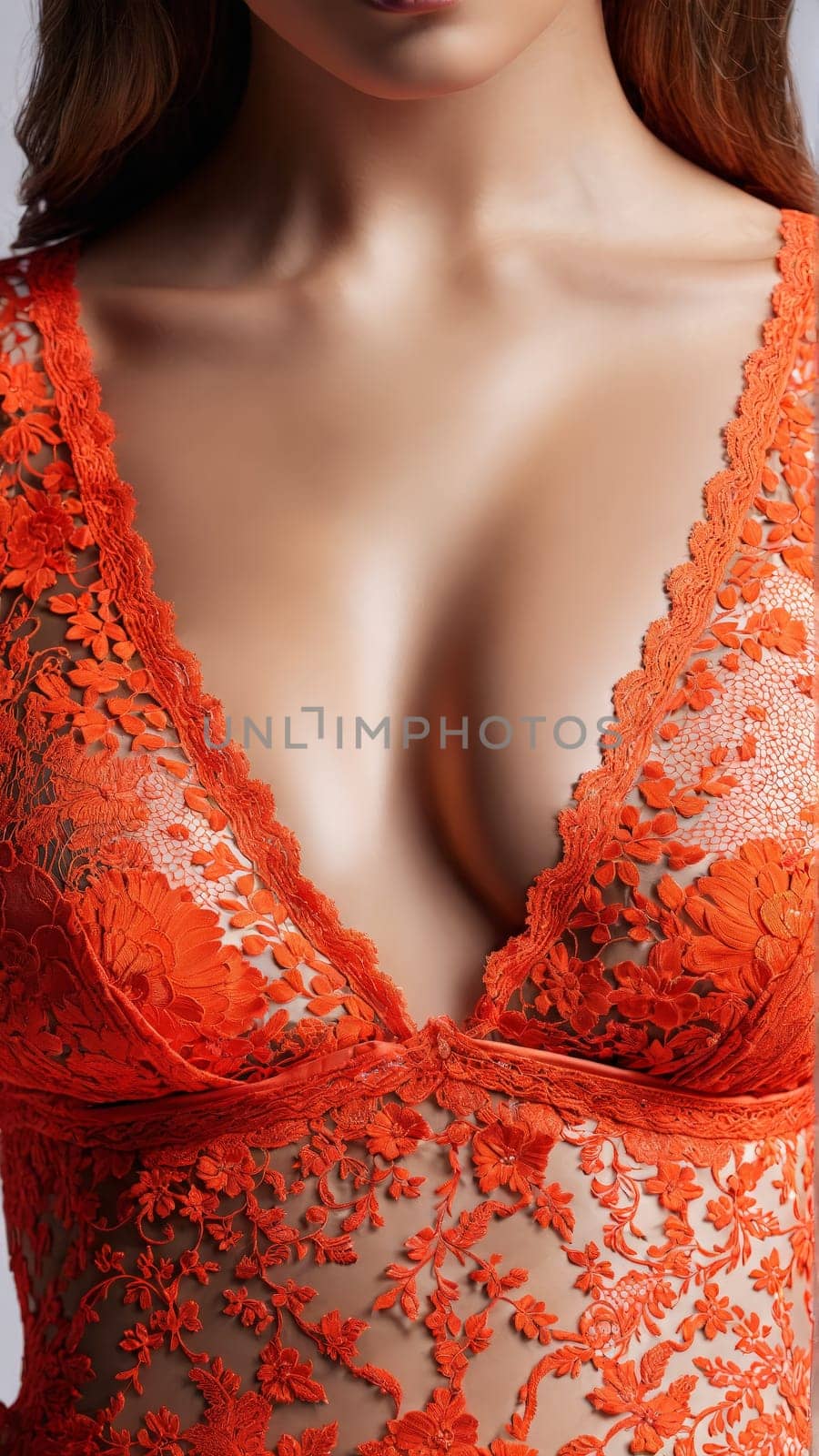 Lace Coral Teddy A vibrant coral lace teddy with a plunging neckline and a cheeky cut. Close up portrait in studio