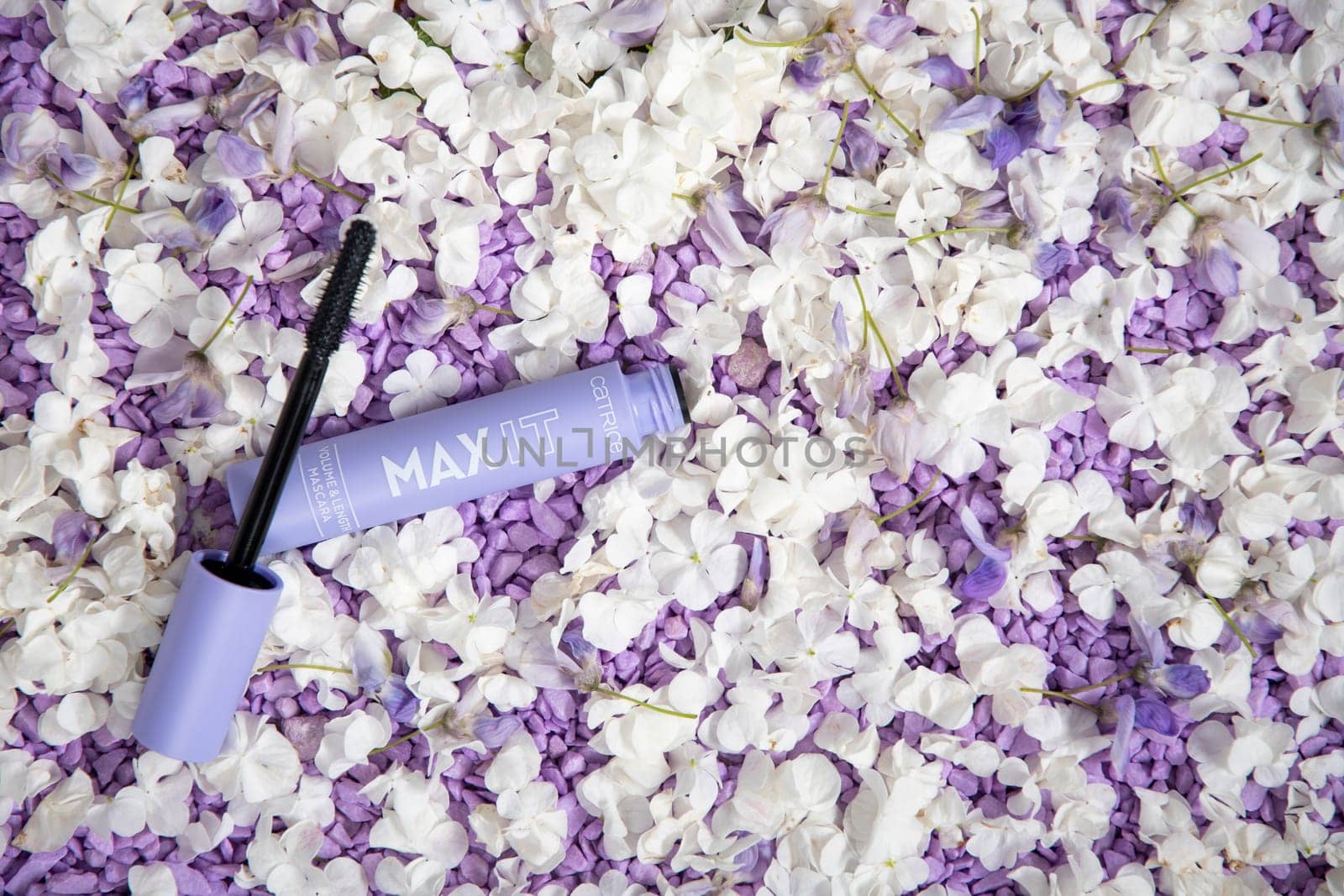 Catrice Yeux Max It Volume and Length Mascara Deep Black in a lilac case against a lilac background of small stones, close up, As,Belgium, May 14, 2022, High quality photo,