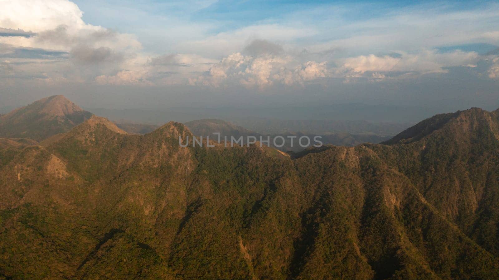 Sunset in the mountains against the blue sky and clouds. Philippines.