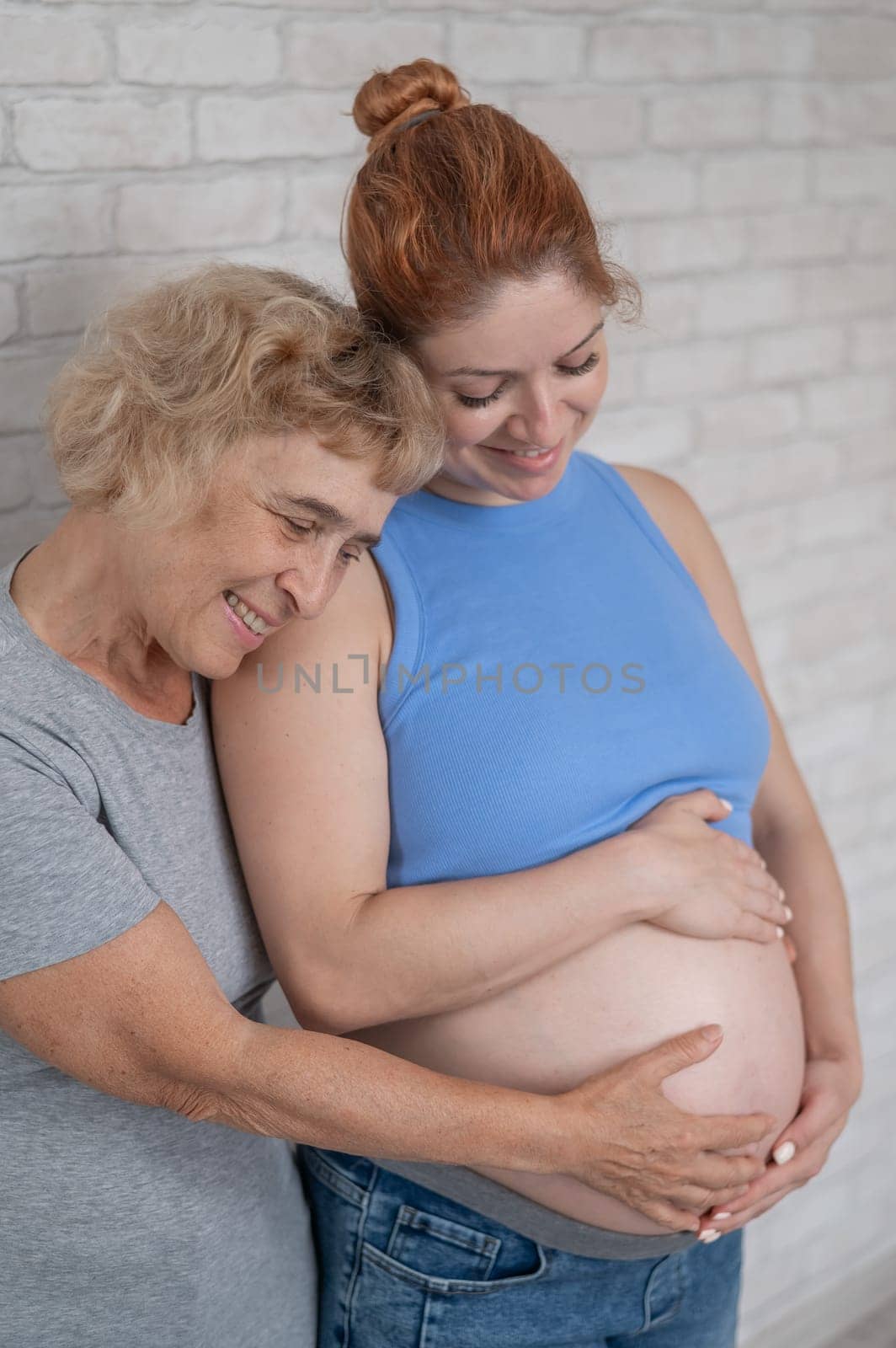 Elderly woman and her adult pregnant daughter. by mrwed54