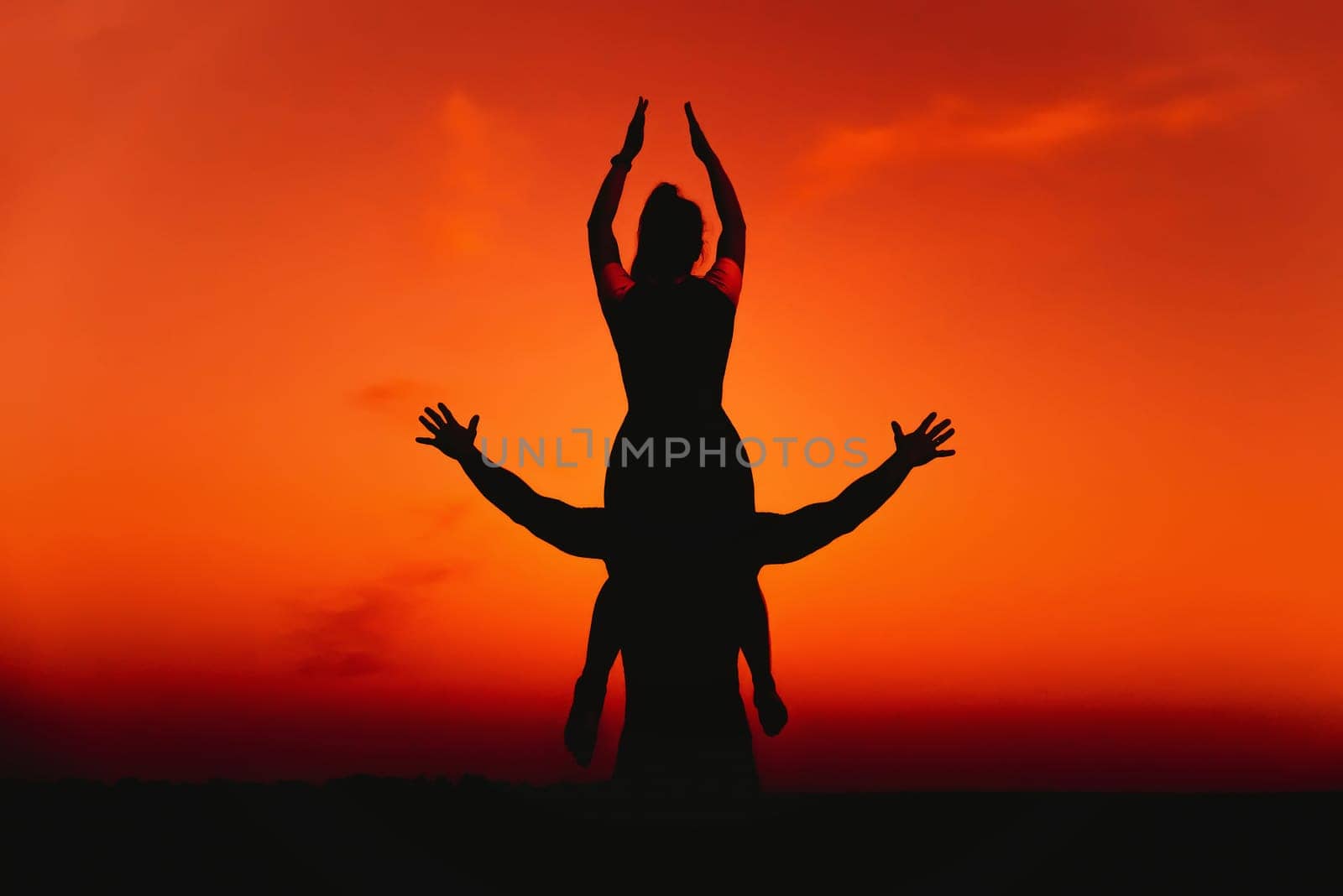 sporty couple sports outdoors in the summer against the background of an orange sunset