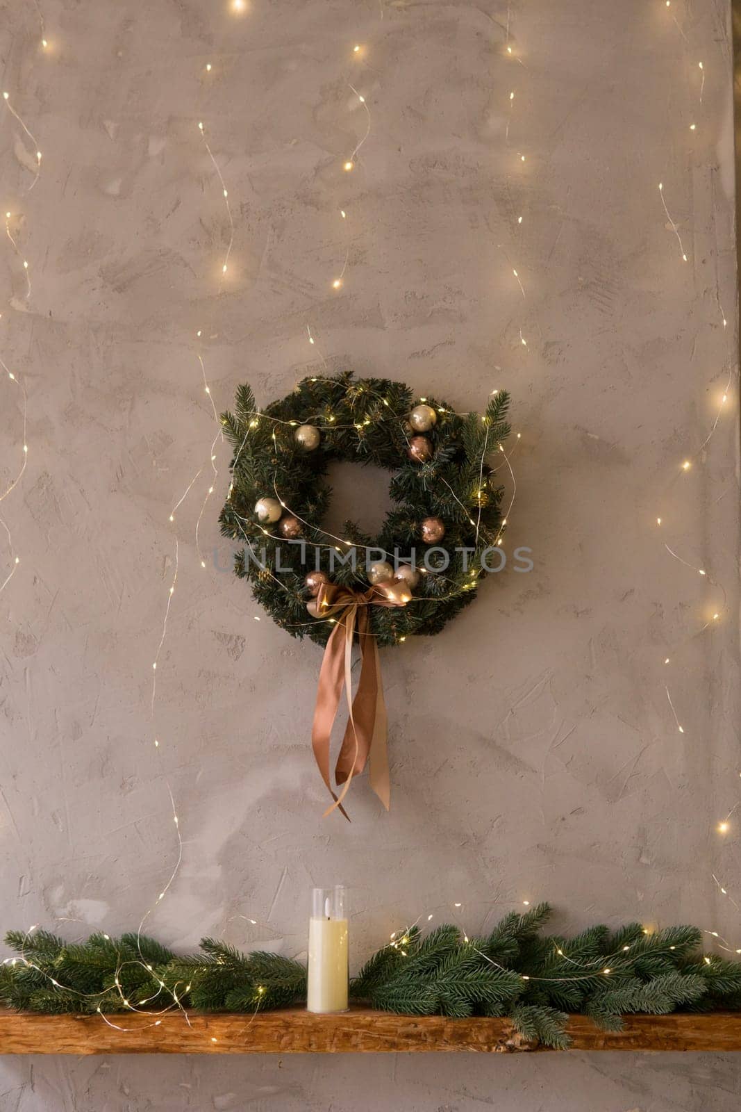 Home New Year's kitchen interior. Decorations with garlands and a Christmas wreath. Cozy atmosphere of a home holiday, loft-style interior design,