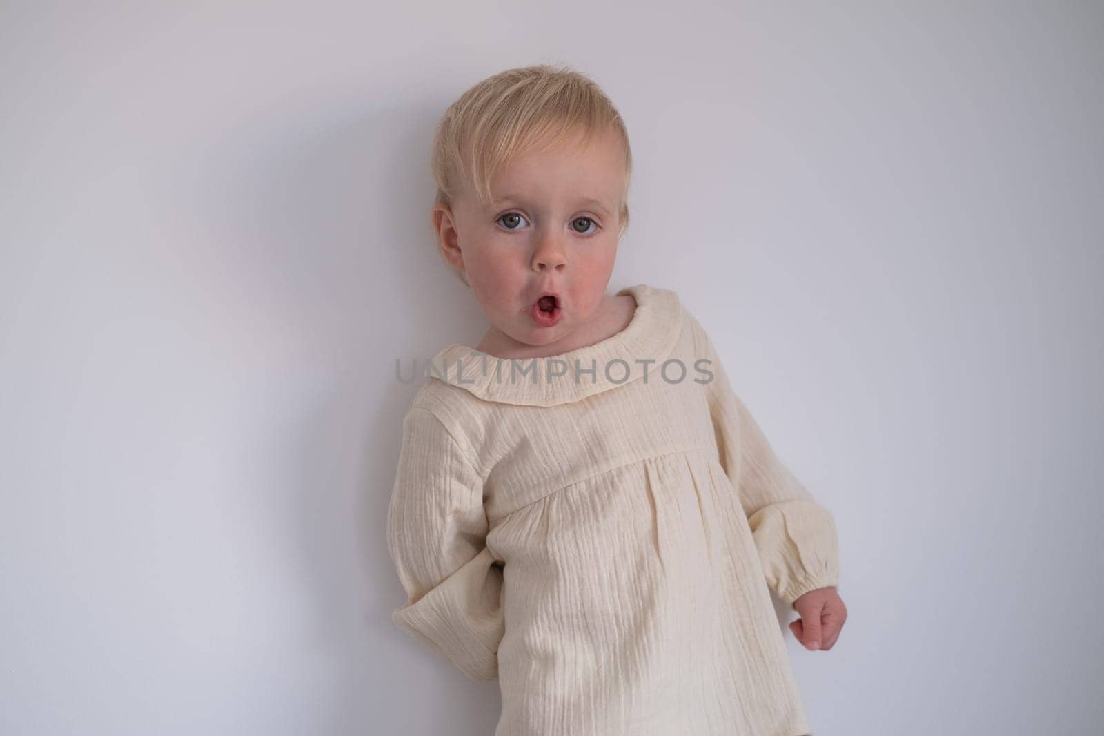 Funny toddler girl looking suspicious and curious. Beautiful child girl closeup portrait