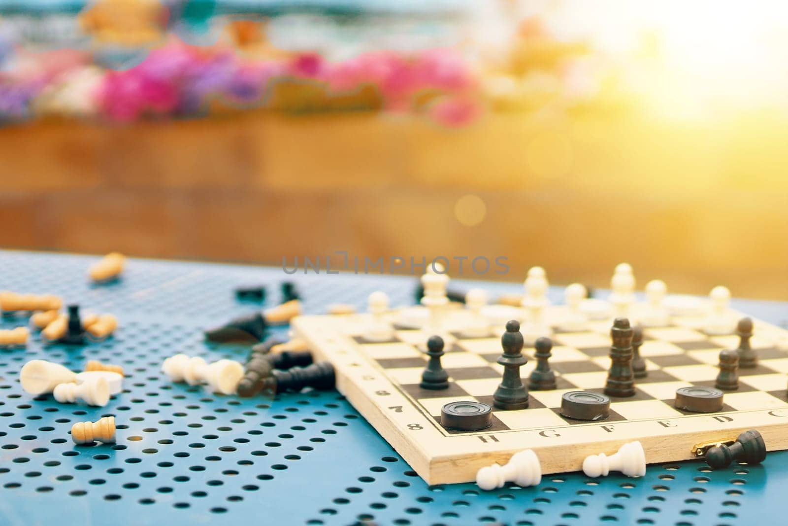 Scattered chess summer day on the green table in the Park