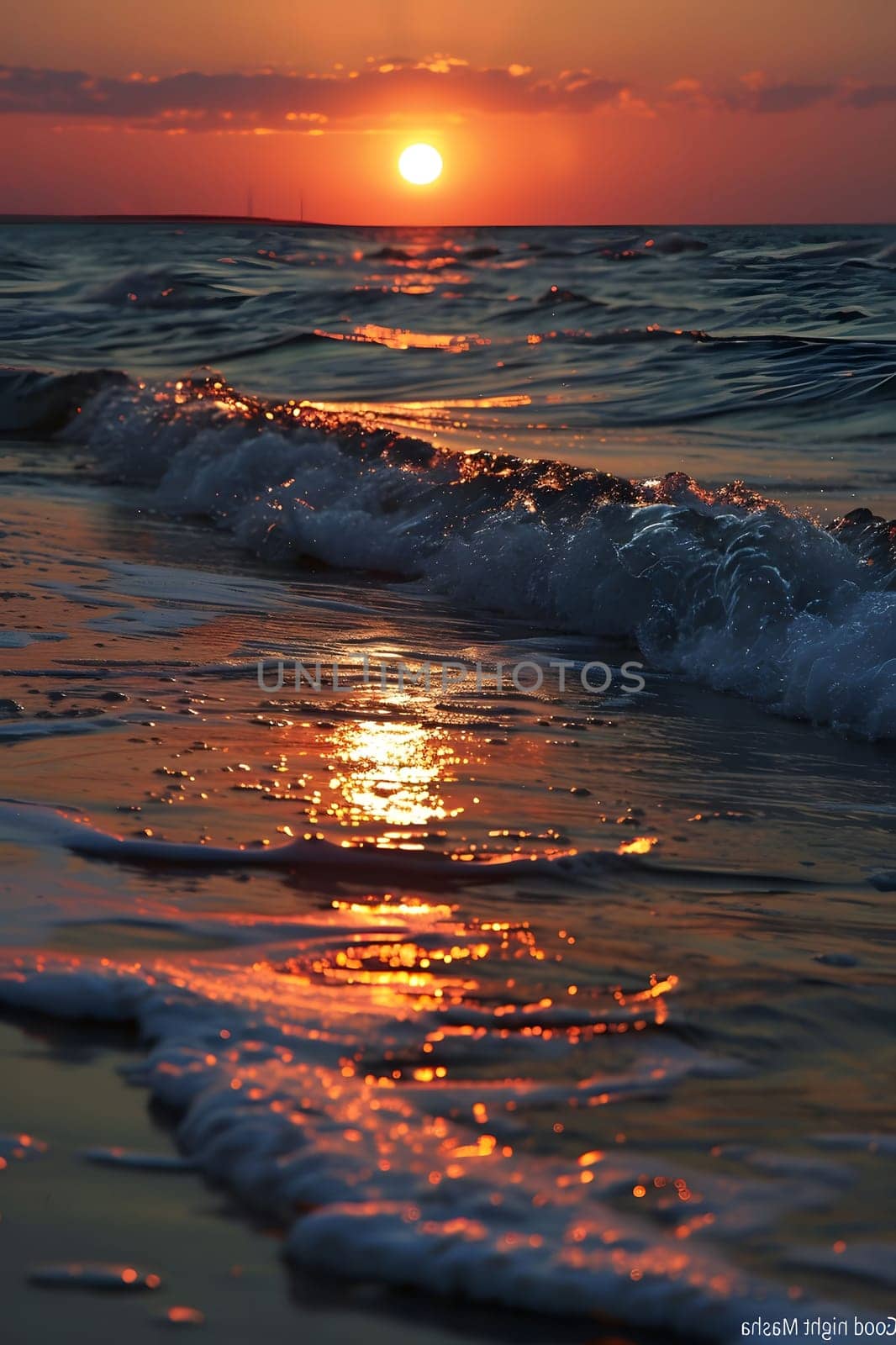 A stunning sunset over the ocean with golden light reflecting on the waves and the sand.