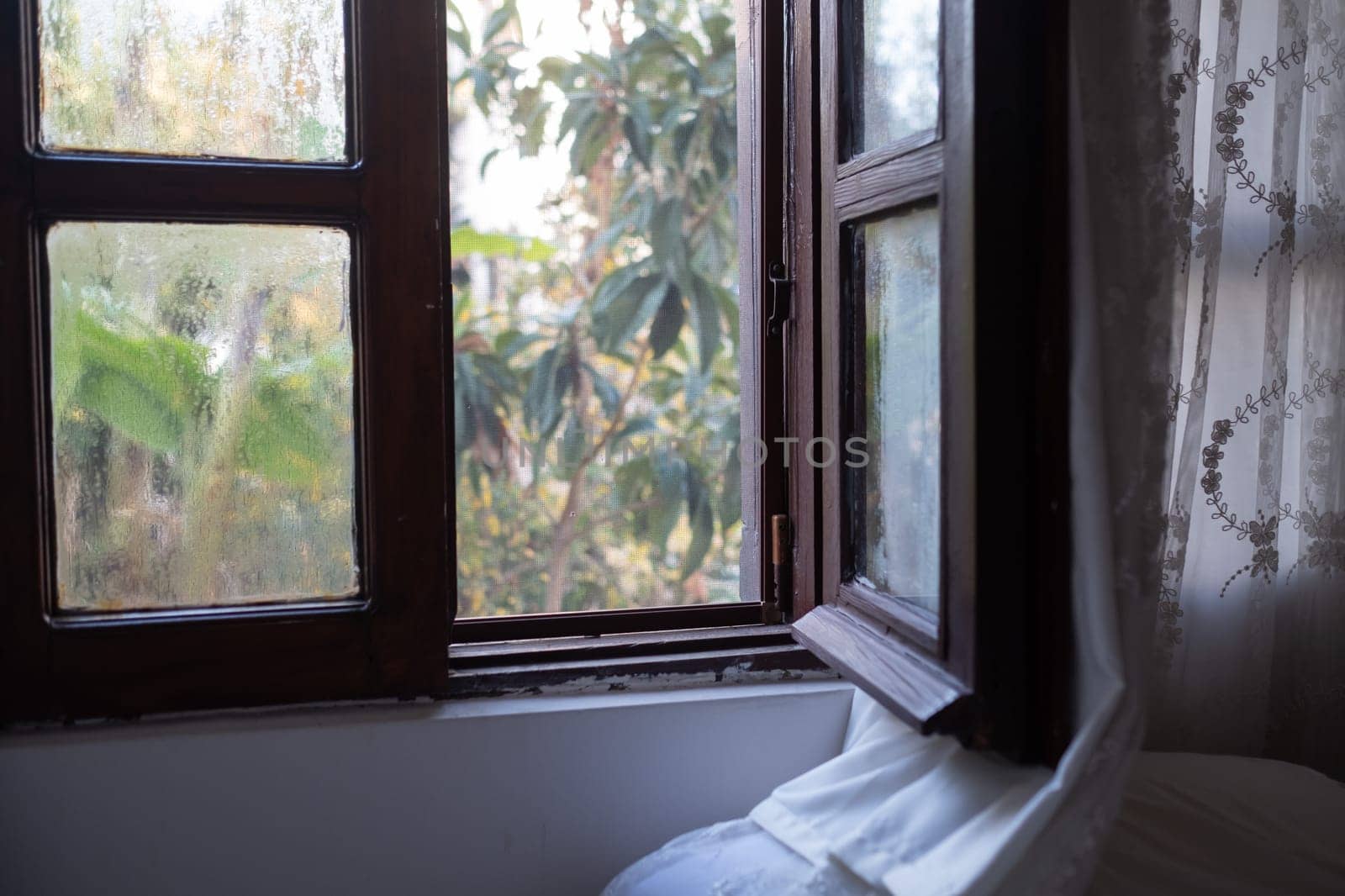Bright morning sun in the open window through the curtains. High quality photo