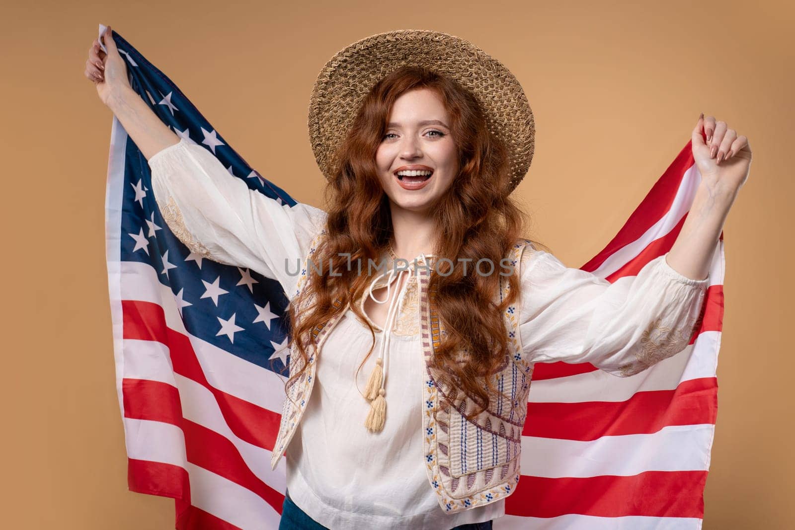 Smiling woman with national USA flag on beige background. American patriot, 4th of July - Independence day celebration, election, America, labor. US banner. High quality photo