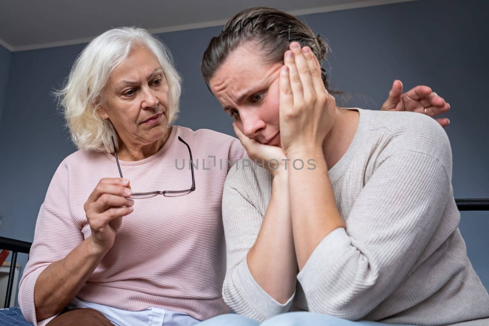 Caucasian Aged mom encourage beloved adult girl child in difficult life situation.