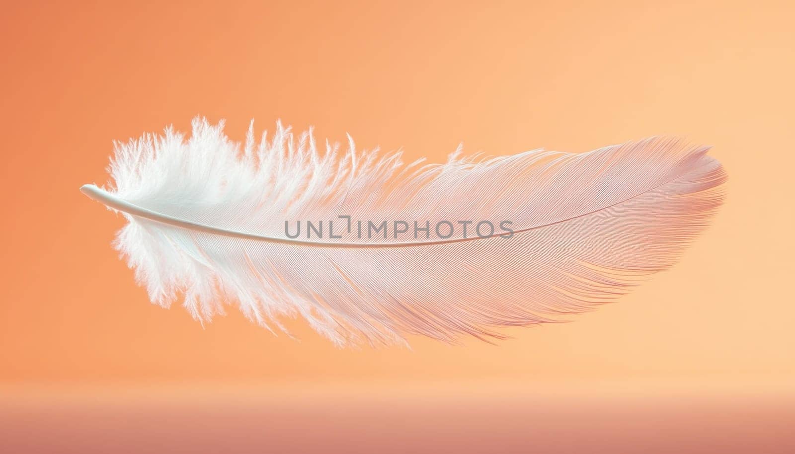 A delicate white feather is gently floating in the air against a vibrant orange background that contrasts beautifully