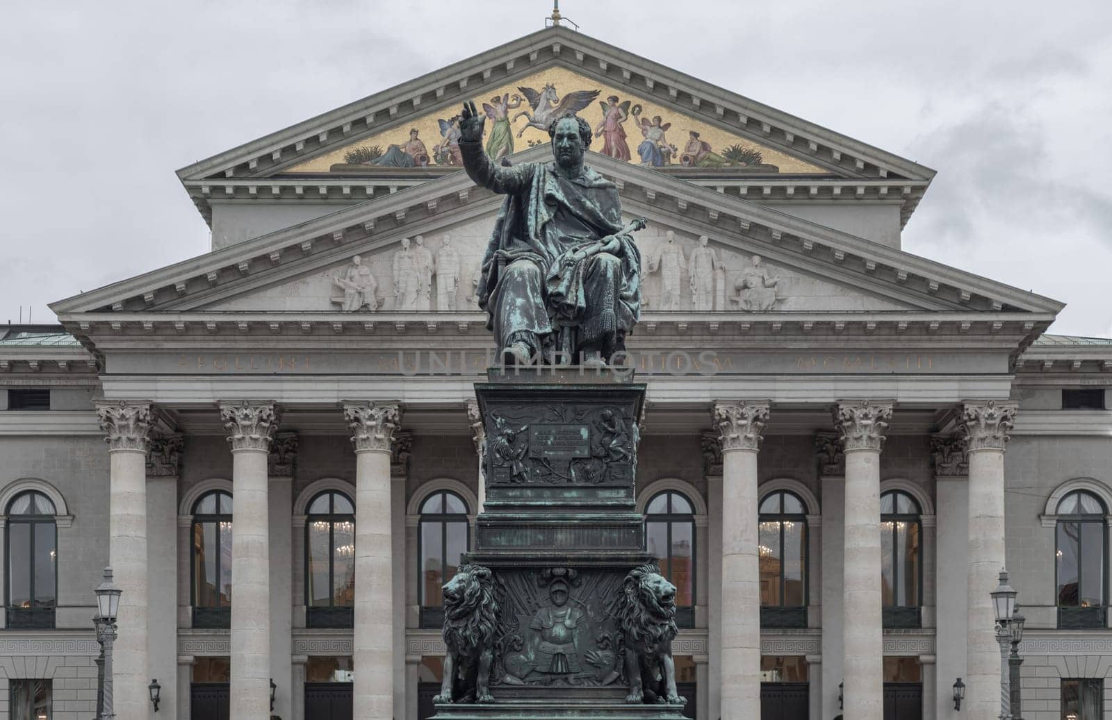 Munich, Germany - Dec 21, 2023 - Monument Bronze Statue of King Maximilian I Joseph of Bavaria in front of The National Theatre of Munich (Nationaltheater) or Bavarian State Opera (Residenztheater) at the Max Joseph Square in central Munich. Space for text, Selective focus.