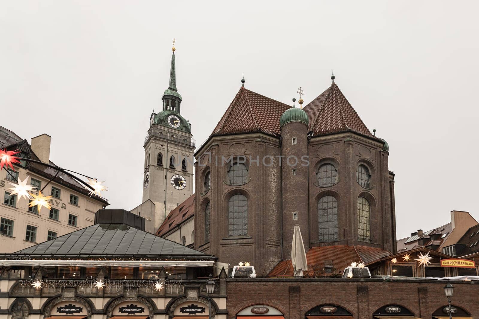 Munich, Germany - Dec 22, 2023 - Marienplatz a central square in the city centre of Munich with St. Peter's Church (Alter Peter) the oldest parish church in Munich. View from the Viktualienmarkt, Space for text, Selective focus.