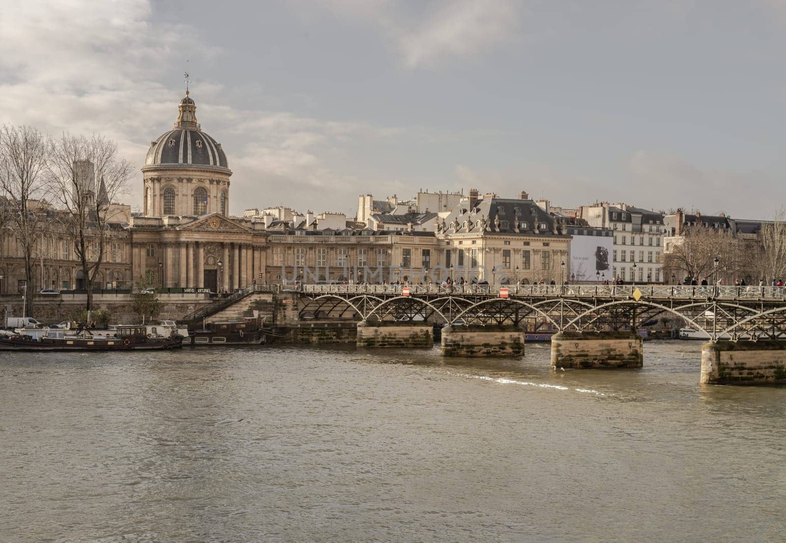 France, Paris - Jan 03, 2024 - Pont des arts (Passerelle des arts) is a pedestrian bridge which across the seine river to The Institut de France in Paris. Copy space, Selective focus.