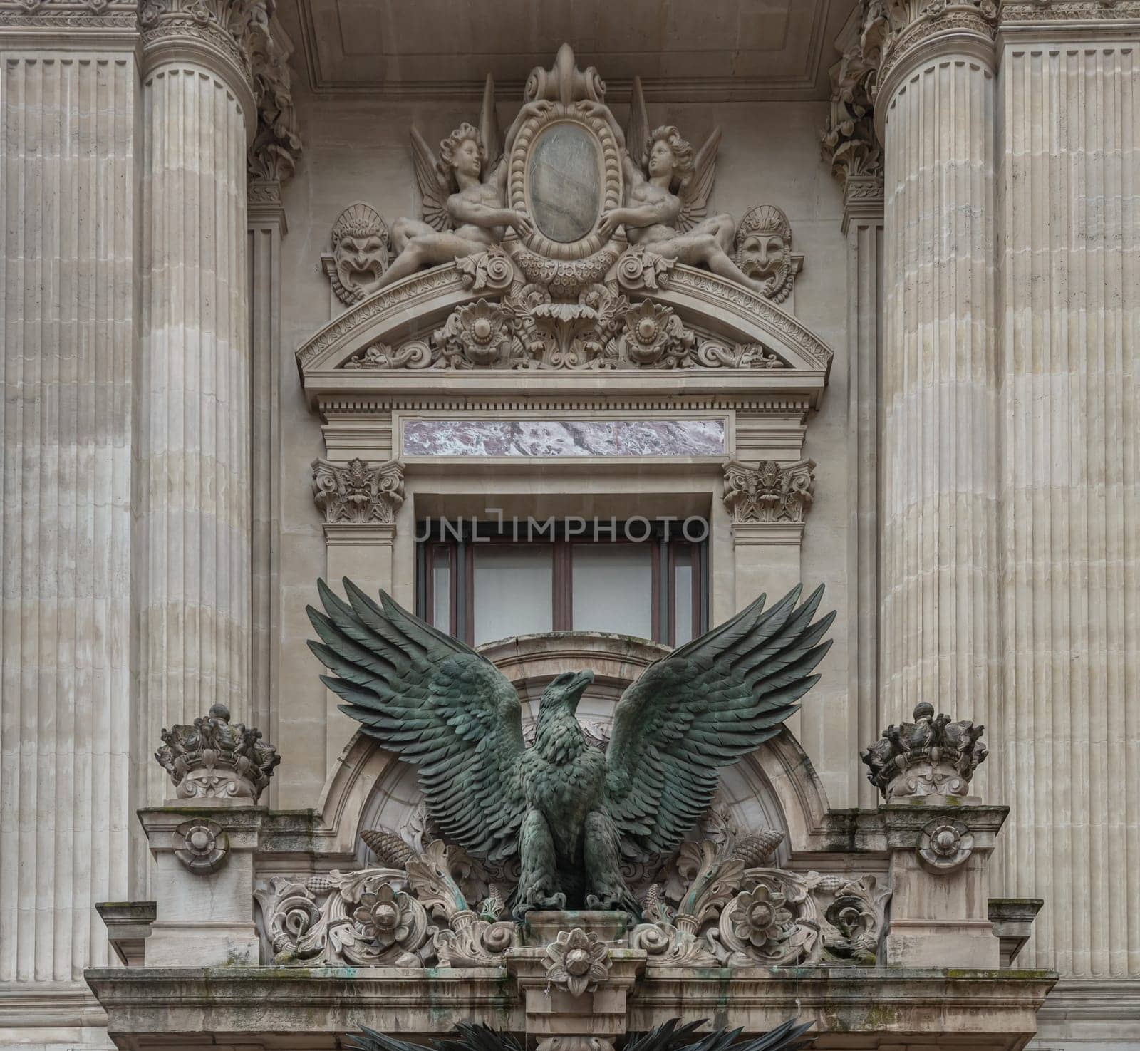 France, Paris - Jan 04, 2024 - Bronze sculpture of The imperial eagle (French Napoleonic) above entrance to The opera house Palais Garnier. Architectural details of The Palais Garnier (Opera National de Paris). Place de l'Opéra (Opera Garnier) is famous Neo-baroque building in Paris, UNESCO World Heritage Site, Copy space, Selective focus.