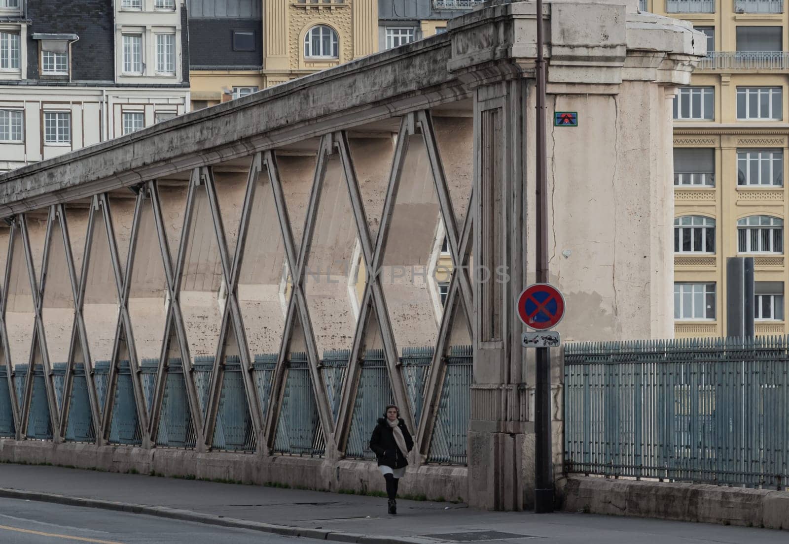 France, Paris - Jan 03, 2024 - People walking along a Bridge on Rue La Fayette. Bridge built above the railways of gare de l'Est, Pont de Lafayette, Rue de l'Aqueduc, Space for text, Selective focus.