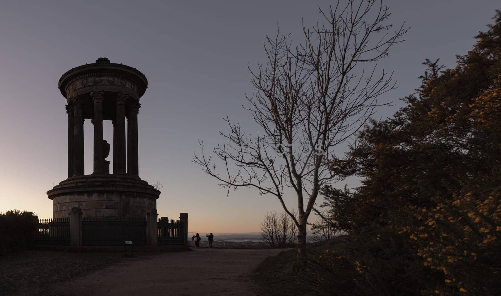 Edinburgh, Scotland - Jan 17, 2024 - Dugald Stewart Monument a memorial to Scottish philosopher Dugald Stewart from the hilltop of Calton Hill at Central edinburgh scenic at sunset. Destinations in Europe, Space for text, Selective focus.
