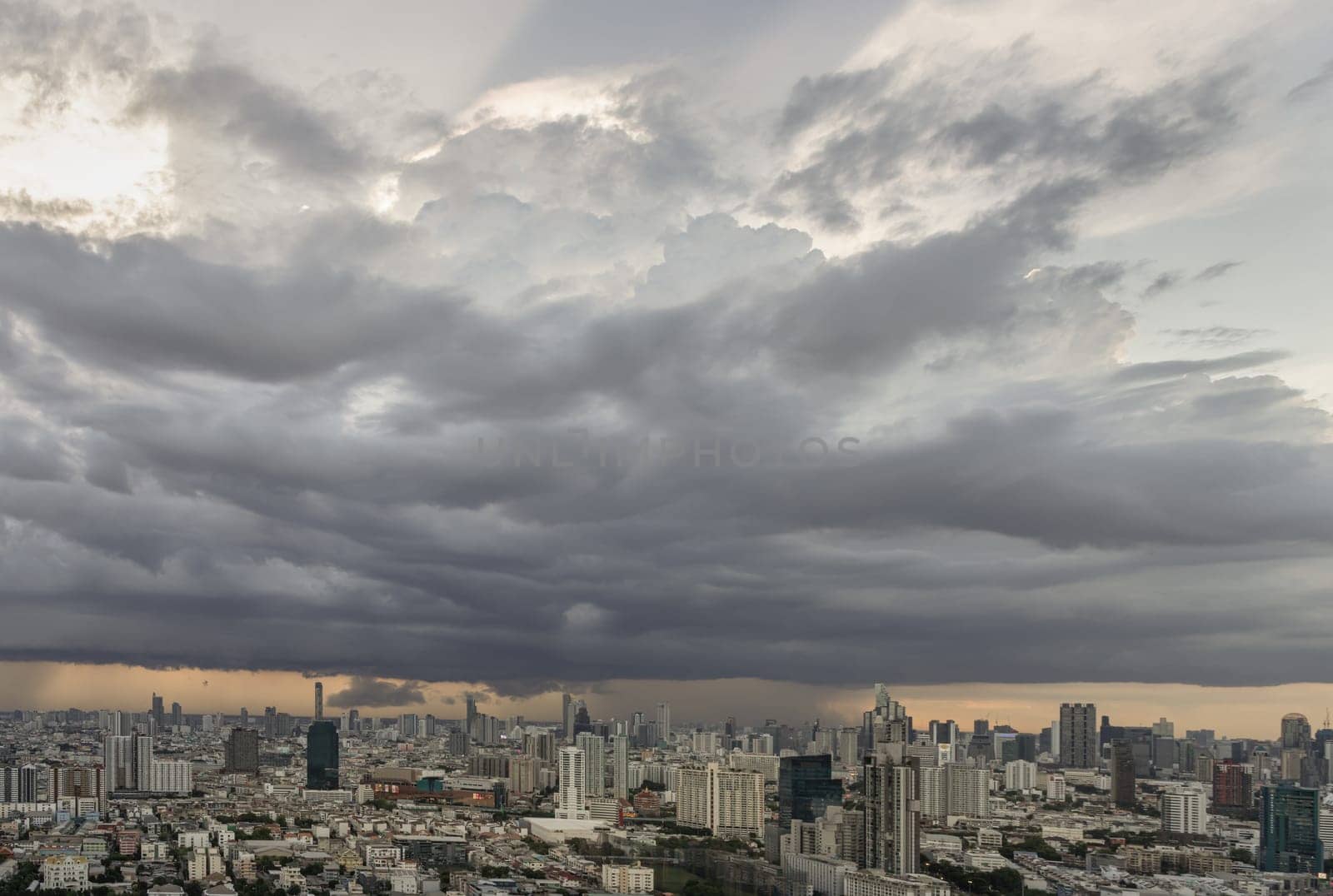 Bangkok, Thailand - 20 Jun, 2024 - Aerial view of skyscrapers and dramatic sky before sunset. Beautiful clouds in the sky over large metropolitan city of bangkok, Copy space, Selective focus.