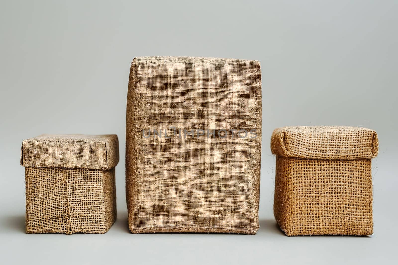 Three burlap-wrapped boxes of varying sizes, showcasing sustainable and eco-friendly packaging solutions. Responsible consumption, eco friendly packaging, zero waste concept.