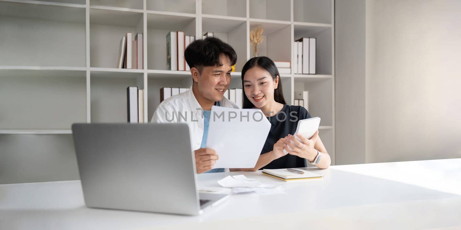 Finance in family concept, Happy Asian couple calculate income and bill to plan for invest or plan income and expenses.