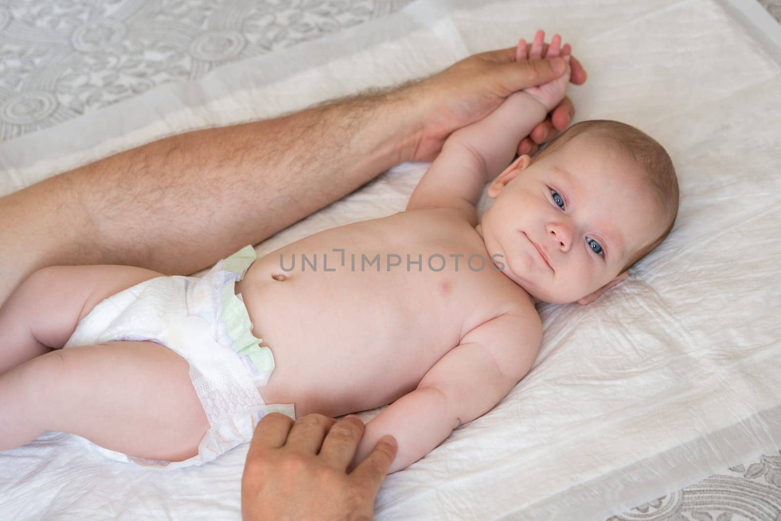 As a loving father, he uses massage techniques to bond and comfort his newborn child