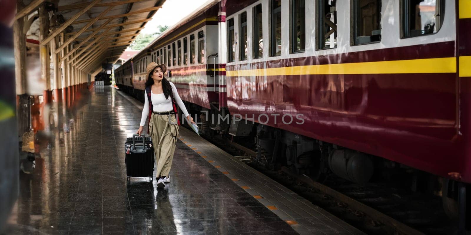 Young woman with suitcase for tourist adventure holiday traveling with a train.concept transport lifestyle active journey and travel lifestyle travel.