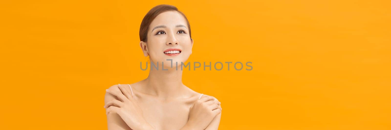 Young lovely woman is touching her shoulder. Web banner by makidotvn
