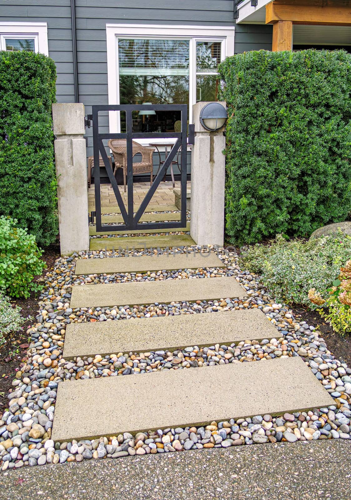 Ground level gated entrance of residential apartment on cloudy autumn day in British Columbia