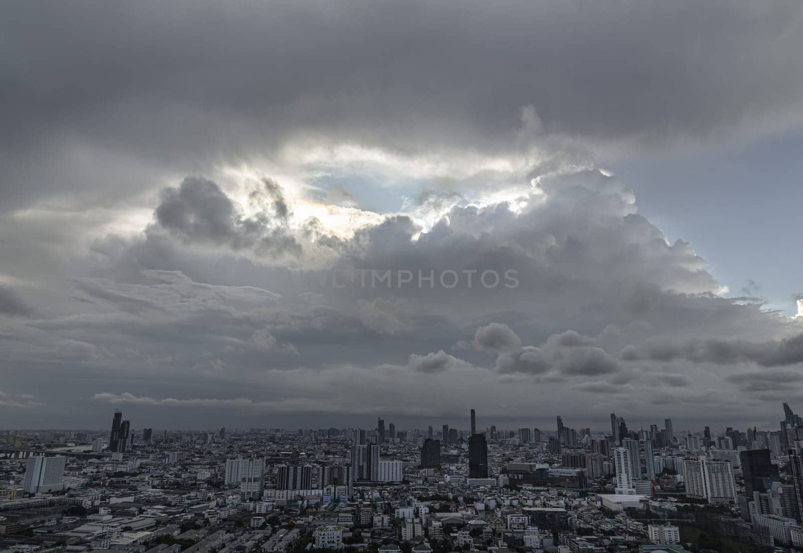 Bangkok, Thailand - 04 Aug 2024 - Aerial view of skyscrapers and dramatic sky before sunset. Beautiful clouds in the sky over large metropolitan city of bangkok, Copy space, Selective focus.